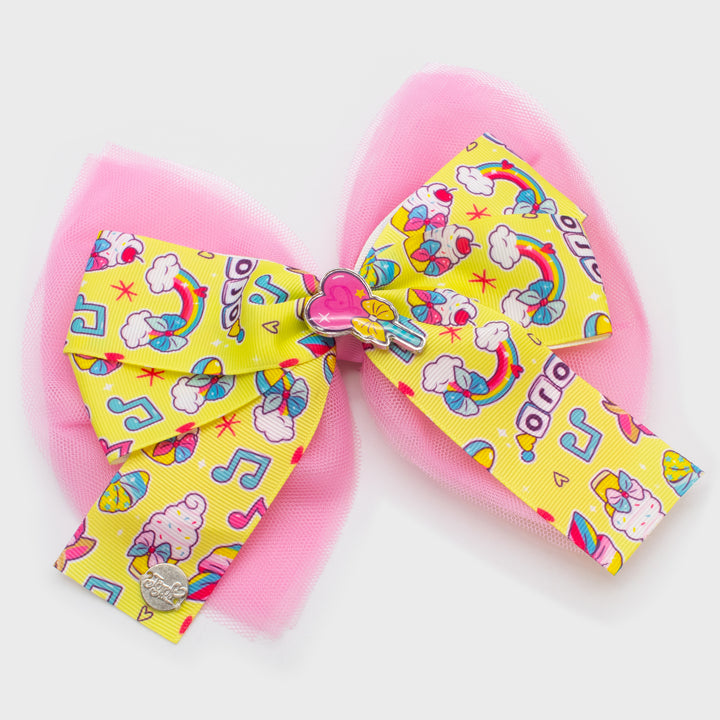 jojo siwa exclusive bow. pattern on bow: cupcakes and rainbows. charm in middle: heart wand.