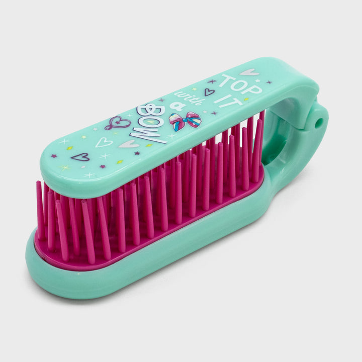 jojo adjustable travel hairbrush. top of it says: top it with a bow.