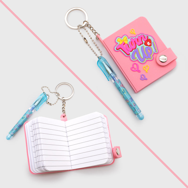 jojo siwa mini notebook keychain with pen. mini notebook cover: turn it up. inside of notebook is line paper.