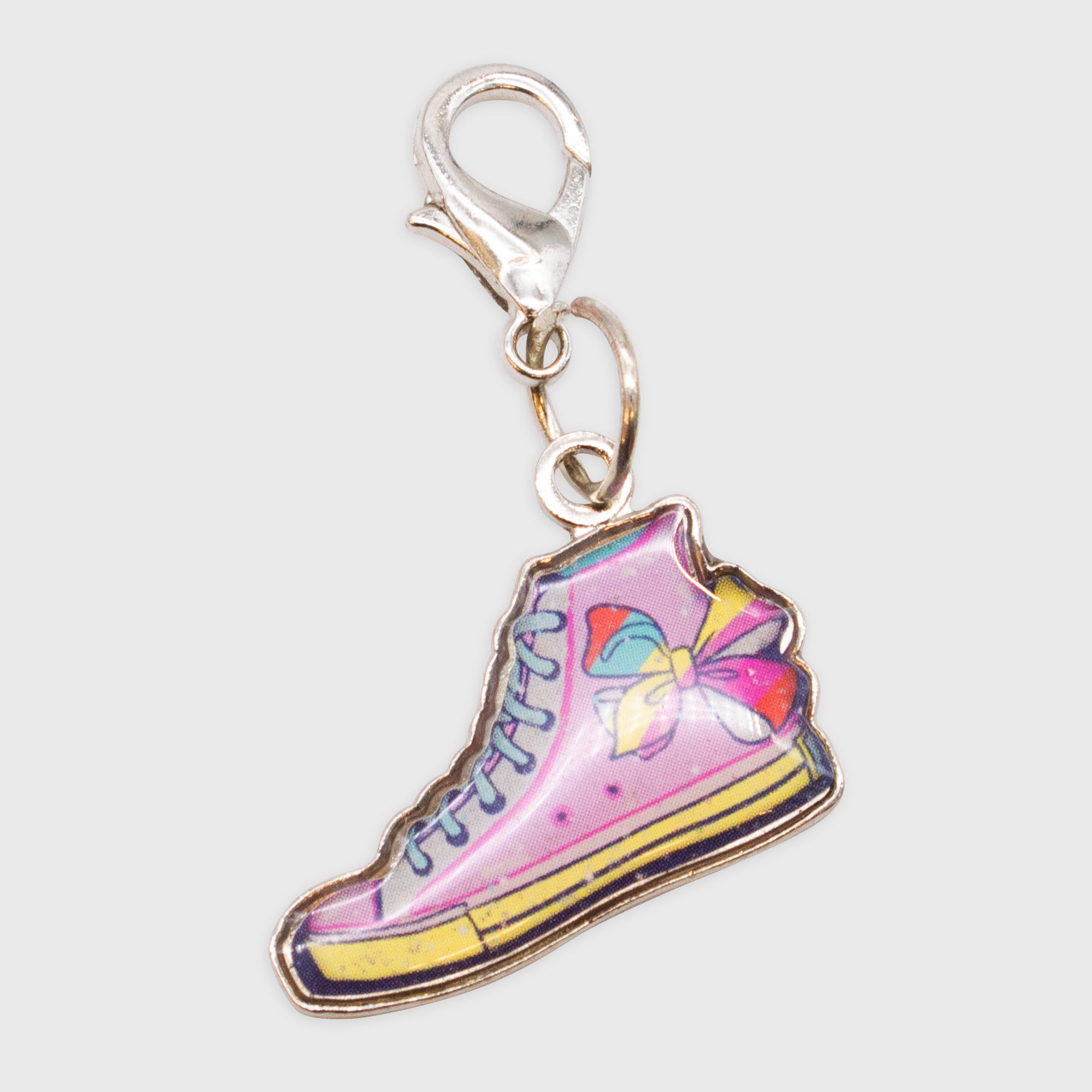 jojo siwa collectible charm. high top sneaker with bow on top of sneaker.