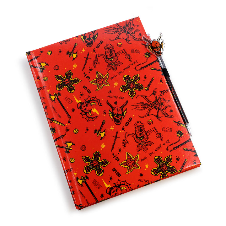 Red notebook with black and yellow designs on a white background