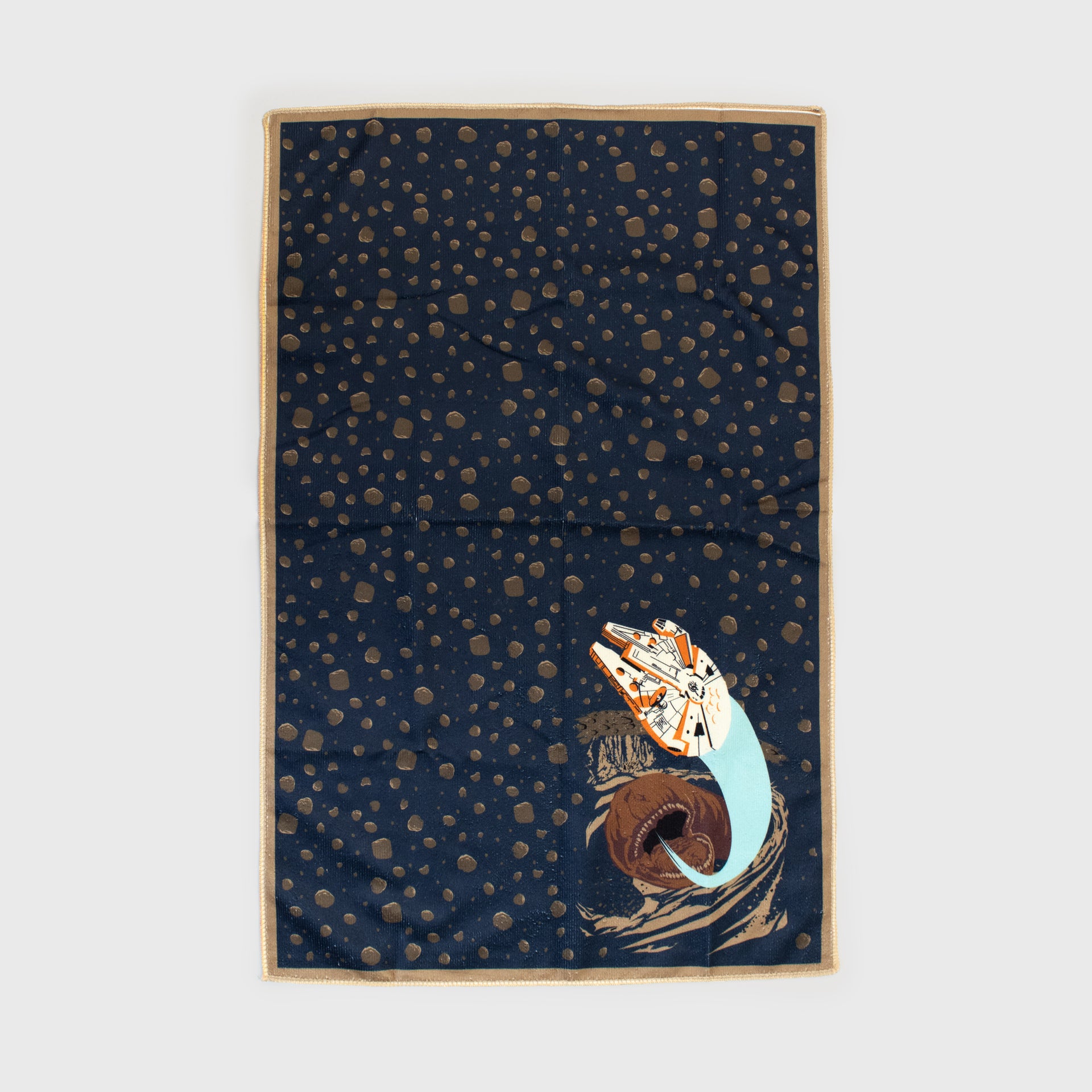 kitchen towel. space rock pattern. image on bottom: millennium falcon flying out of the Exogorth.