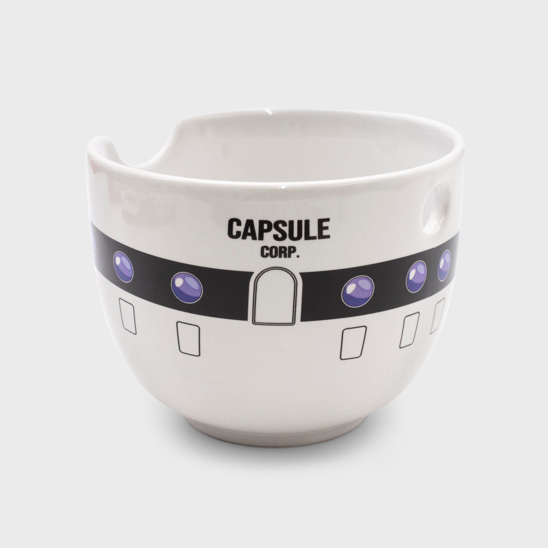 ramen bowl. looks like capsule corp building. text says capsule corp. has holes to hold and rest chopsticks