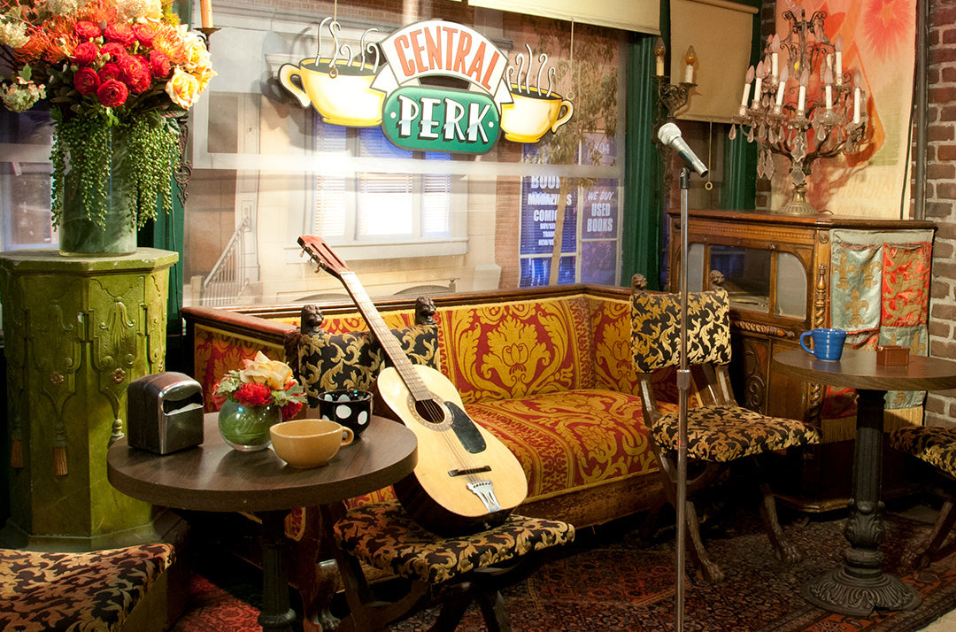 central perk cafe interior with furniture, guitar and mic