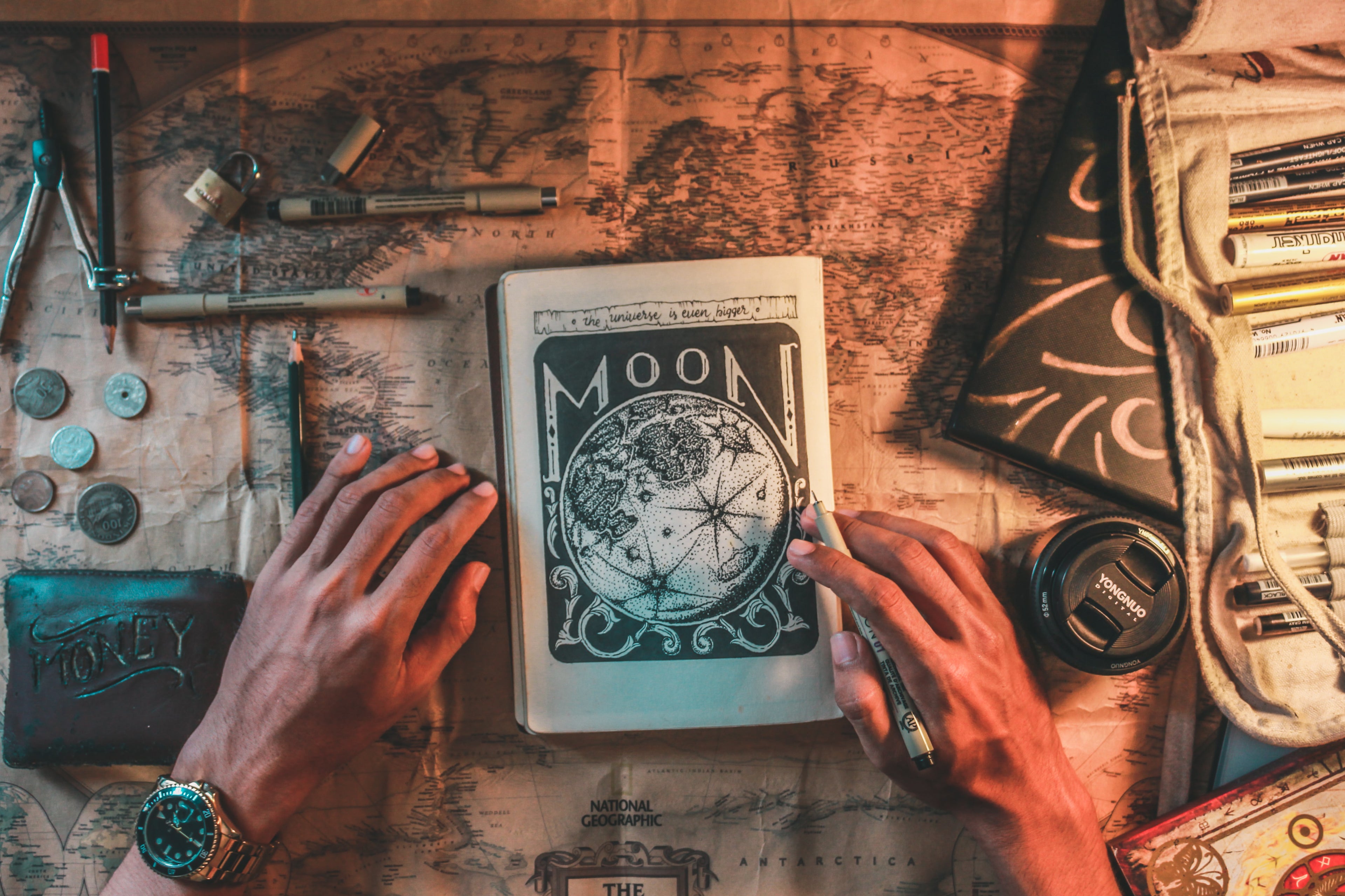 mysterious book on a table with world map and other accessories  