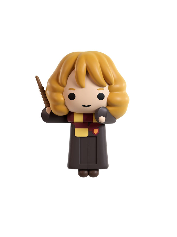 A small stylized collectible figurine of a blonde character in a dark robe with a yellow and red scarf, holding a wand, shown on a plain white background.