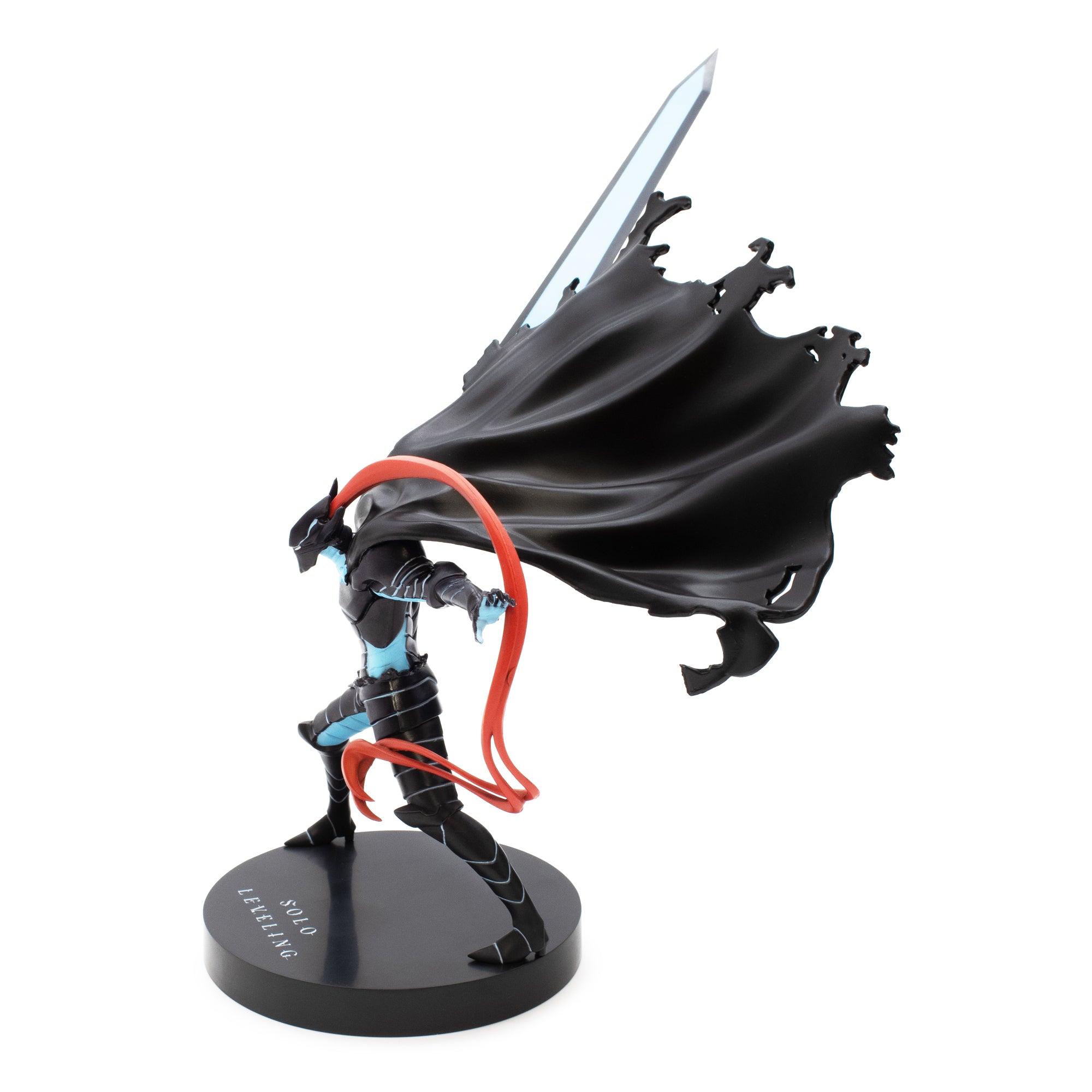 Figurine of a character with a large black cape and sword on a white background