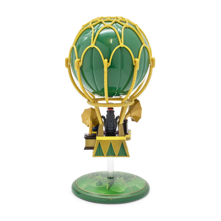 Model of a hot air balloon with green balloon and yellow basket on a white background
