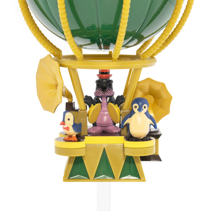 Toy hot air balloon with penguin characters on a white background