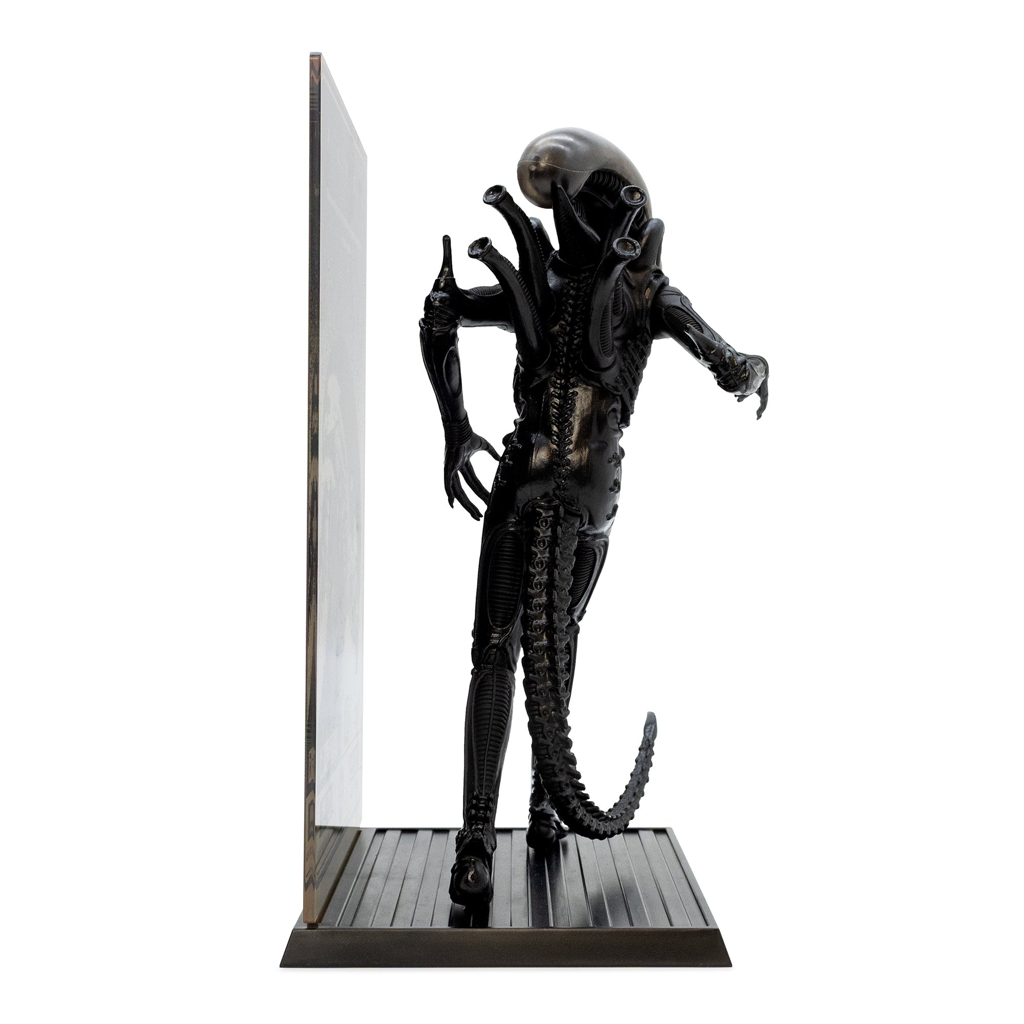 Alien figurine on a stand with a white background