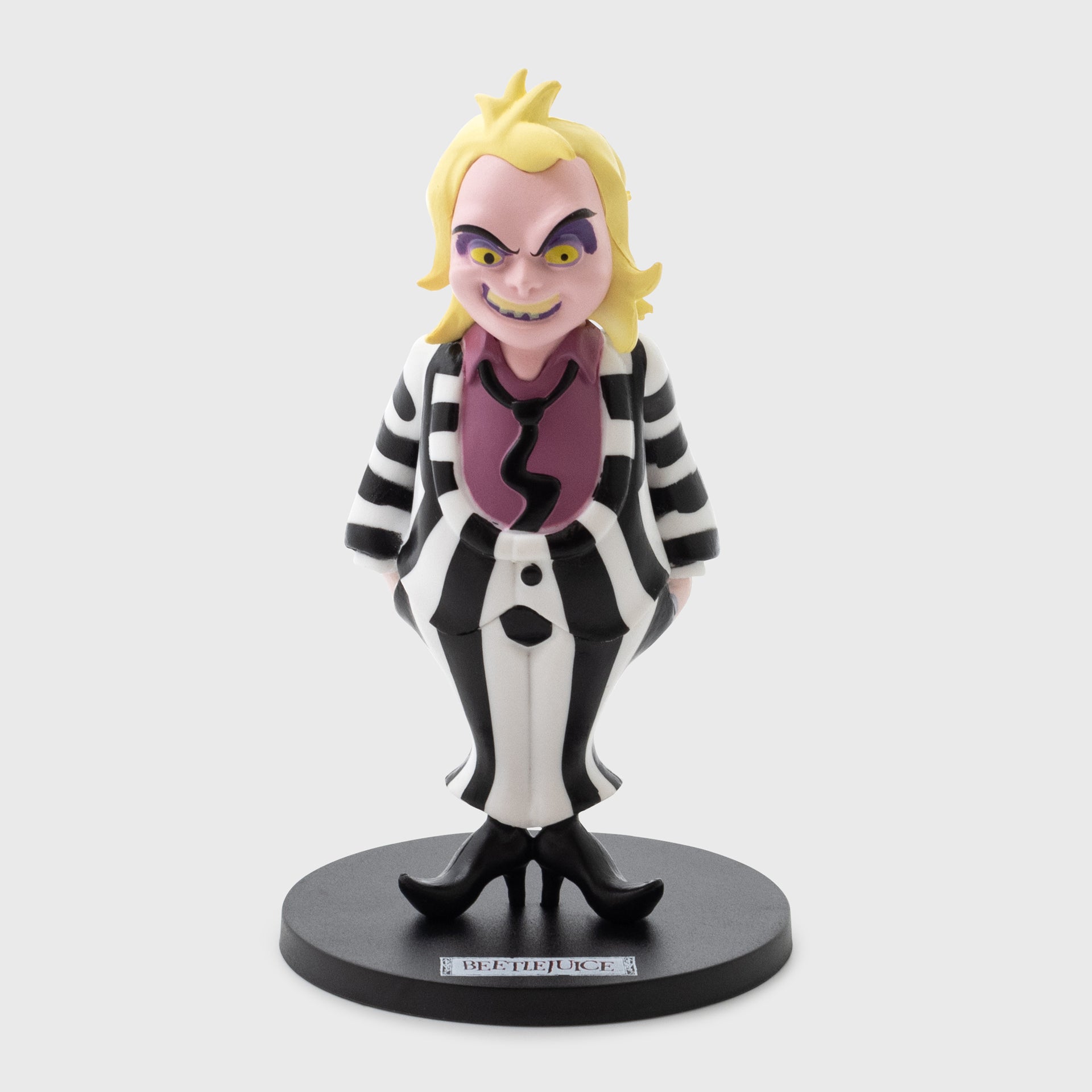 cartoon beetlejuice vinyl figure. text on stand: beetlejuice