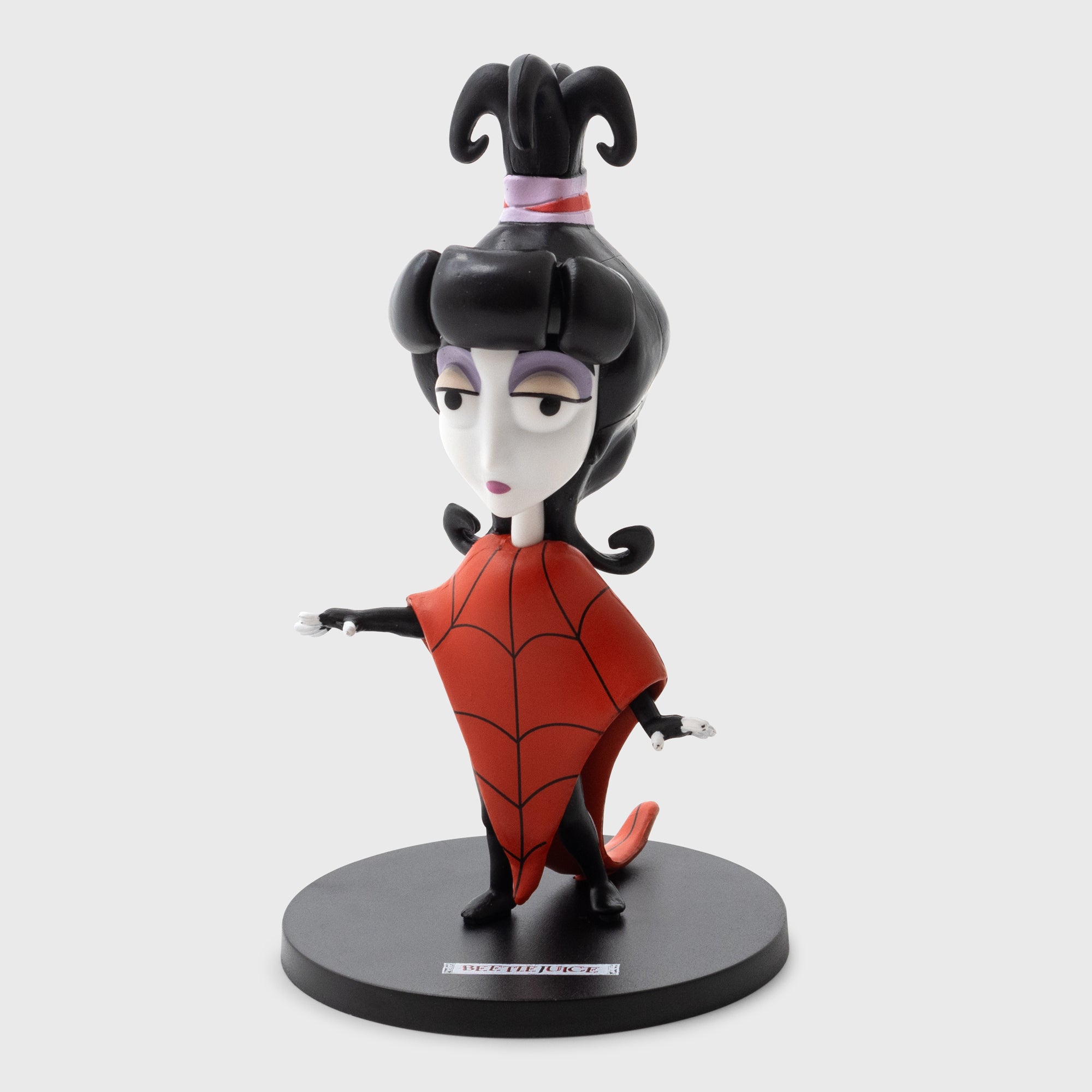 cartoon lydia deetz vinyl figure. text on stand: beetlejuice