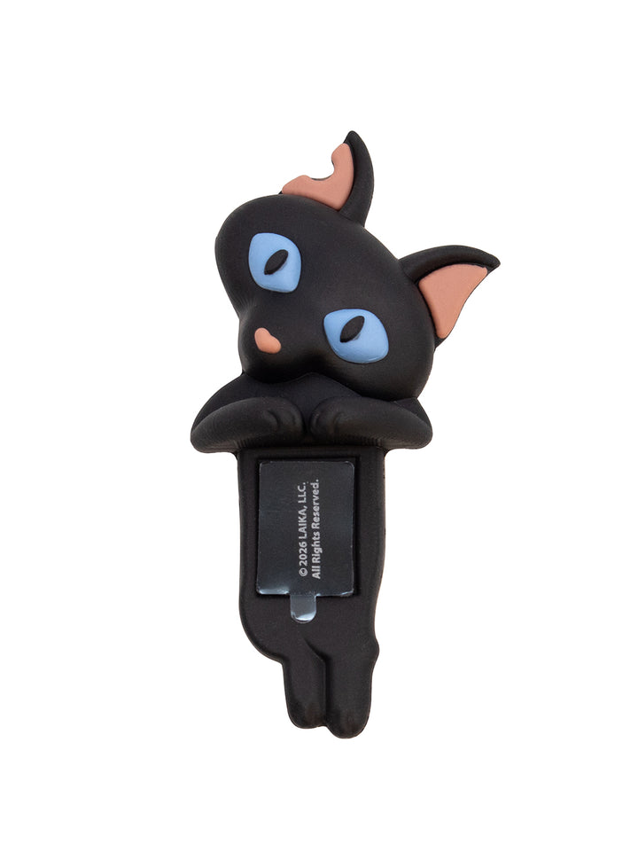 A black cat-shaped car window clip with blue eyes, pink inner ears, and a black mounting clip attached below, shown on a plain white background.