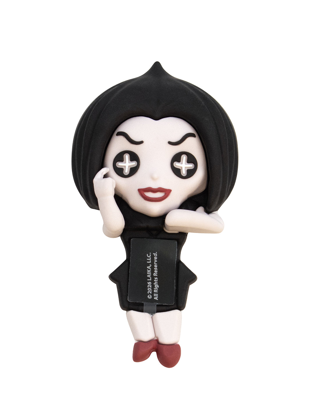A stylized chibi figurine of a woman with short black hair, a black dress, and red shoes, posed with her hands near her face on a plain white background. A small black tag is attached to the dress with white text.