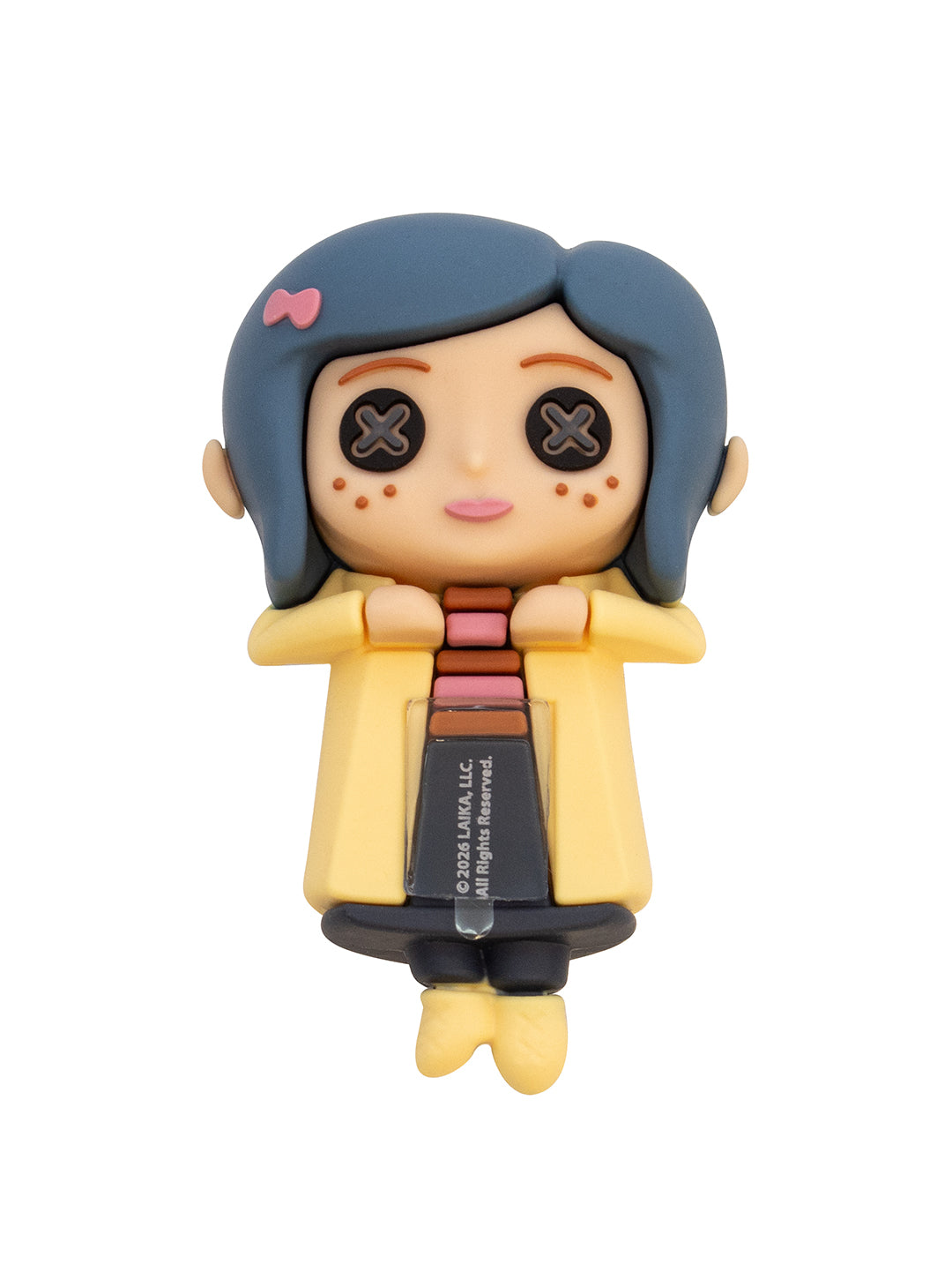 A collectible vinyl figure of the doll version of Coraline, featuring her signature blue hair, yellow coat, and black pants, shown on a plain white background.