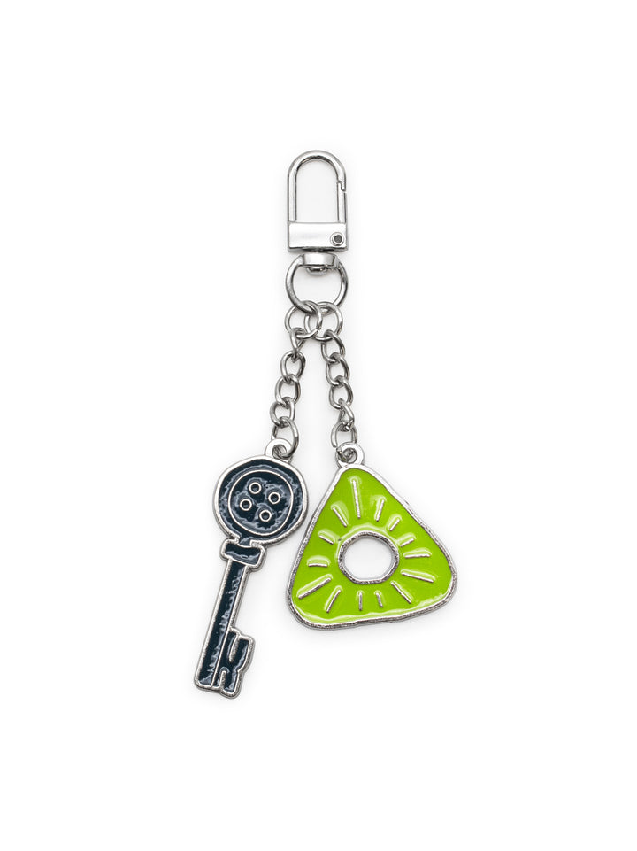 A silver-tone metal keychain featuring two charms: a silver key and a bright lime green guitar-shaped charm with a sunburst pattern.