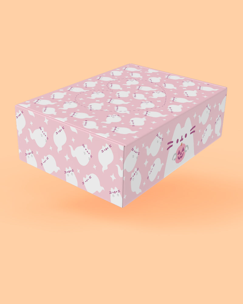 A pink rectangular gift box with a repeating white cat pattern and small text, shown floating against a peach-colored background.