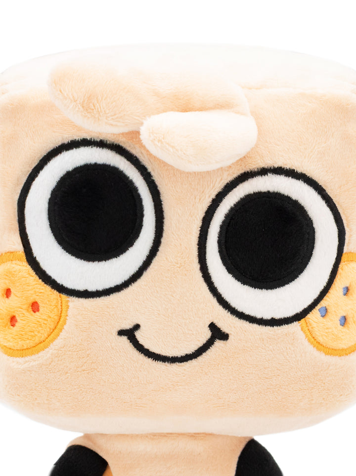 Close up of Goob plush face. Two eyes, two cheek spots, curl of hair, smile