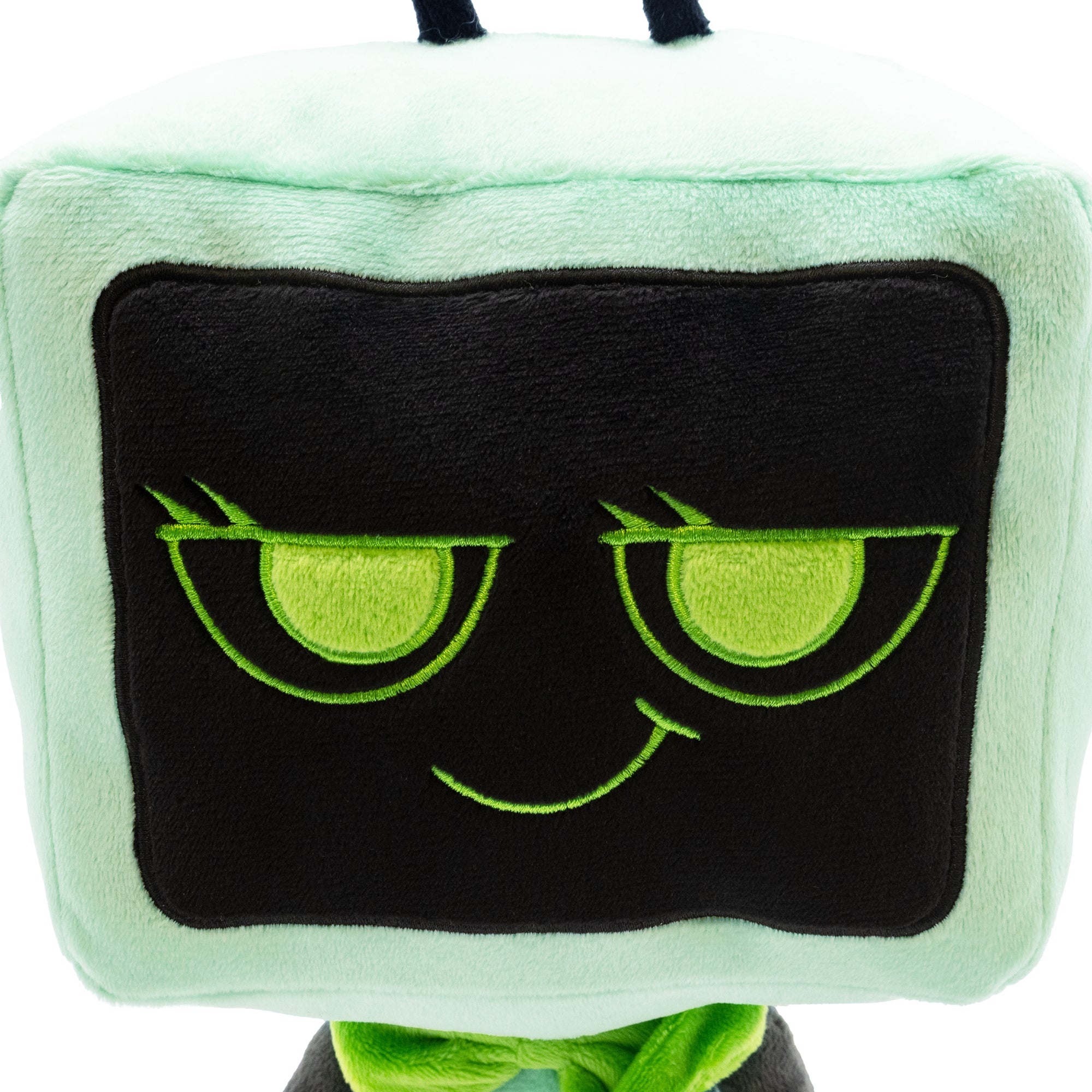 Plush toy with green eyes and a black mask on a white background