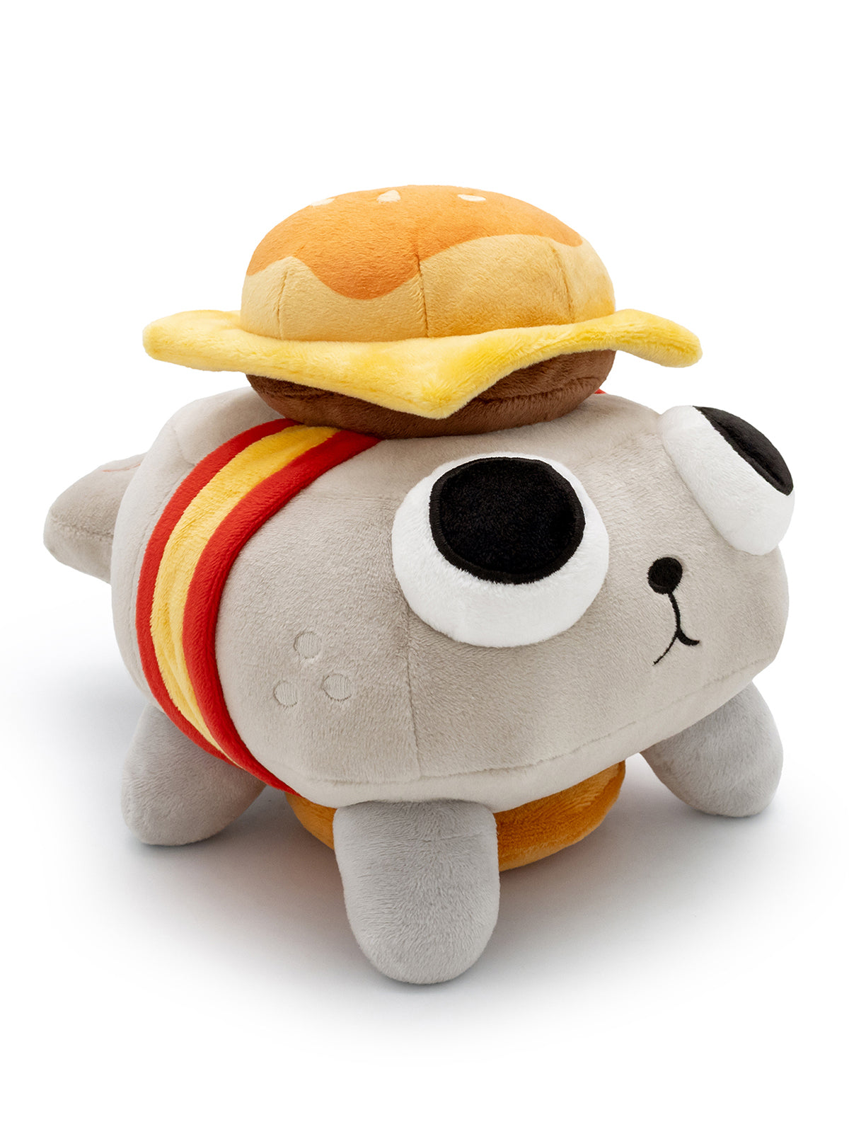 Pebble plush with cheese burger on his head and bottom. facing right.