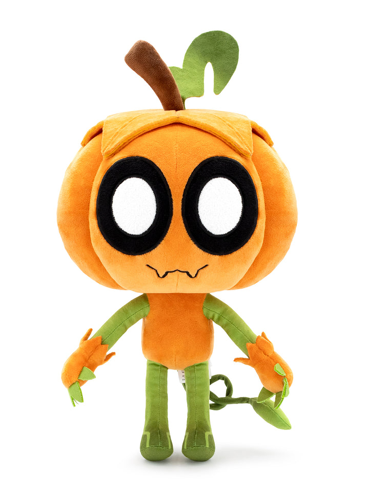 A plush toy character shaped like a smiling orange pumpkin with large white eyes, a brown stem, green leaves, and green arms and legs, standing against a plain white background.