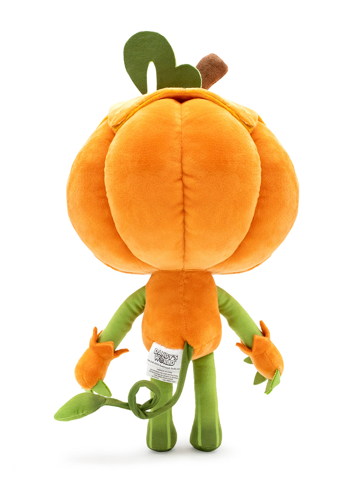 An orange pumpkin plush toy shown from the back, featuring a large round orange body, green stem and leaves, and small orange flower buds on its arms, photographed on a white background.
