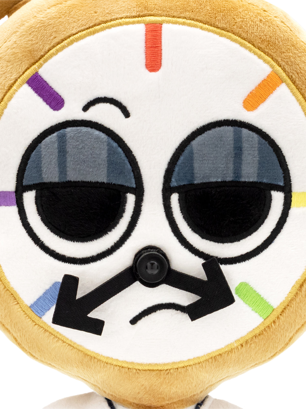 close up of dyle plush face. two eyes with drooping eyelids. clock face with two arrow hards facing down. frown. small eyebrow
