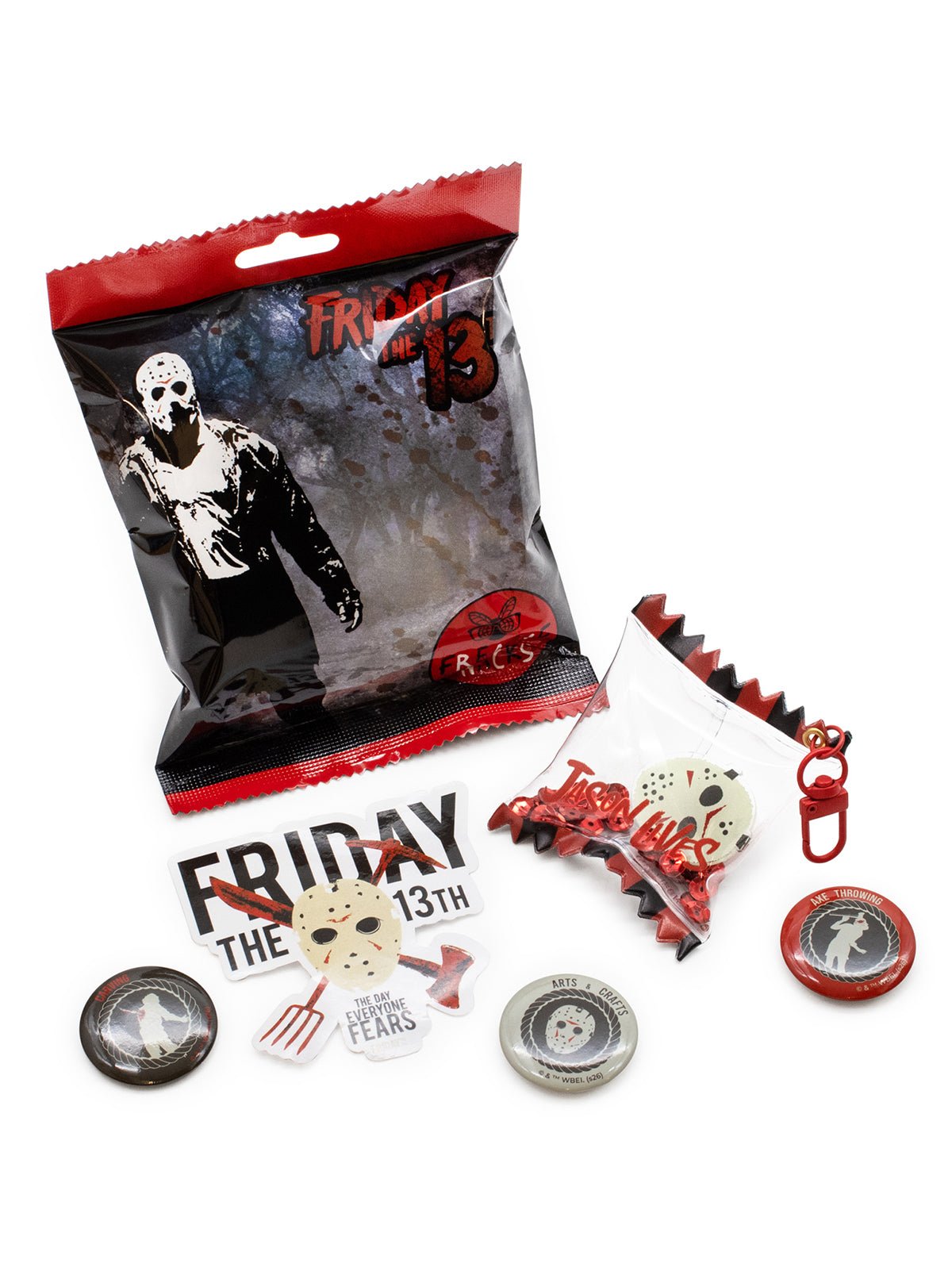 A Friday the 13th themed merchandise set on a white background, including a sealed blister pack with a hockey mask graphic, a small bag of red and white accessories, a printed card, and several round pins or badges.