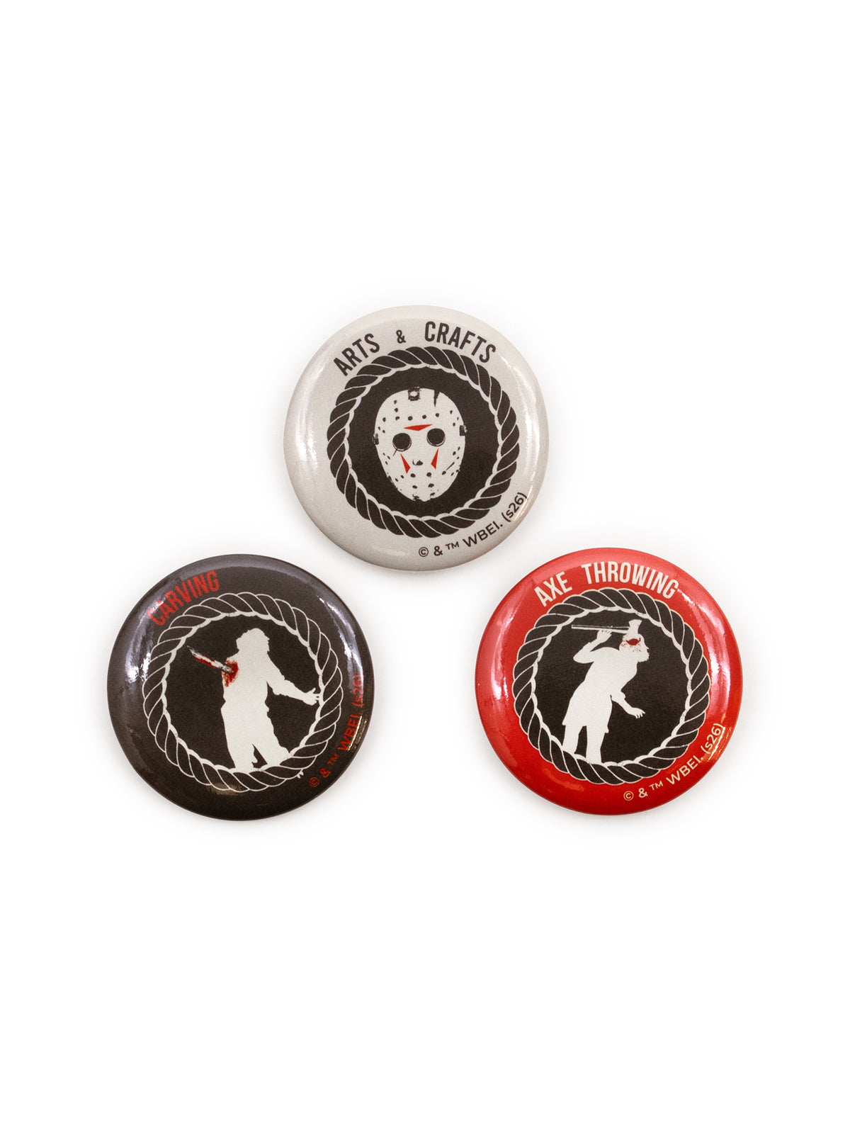 Three circular pin-back buttons with horror-themed designs on a white background. One button is white with a hockey mask and the text 'ARTS & CRAFTS'; one is black with a white figure and the word 'SLAY'; and one is red with a white figure and the text 'AXE THROWING'.