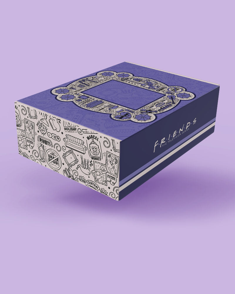A purple and white Friends-themed product box with the iconic circular mirror frame design on top and hand-drawn doodles around the sides, shown floating against a solid lavender background.