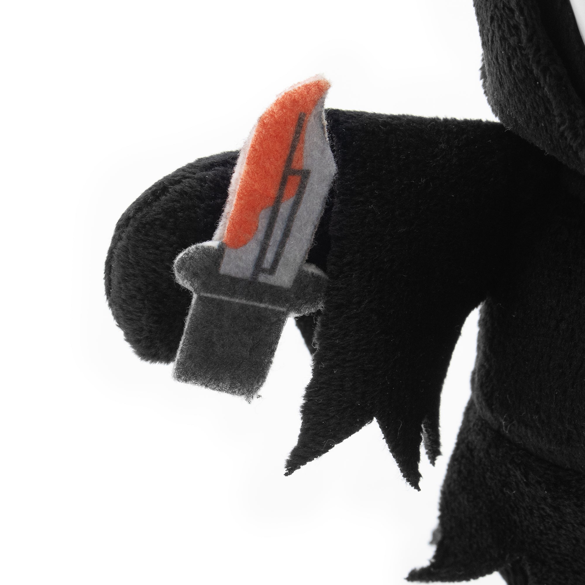 Plush toy with a black and red knife on a white background