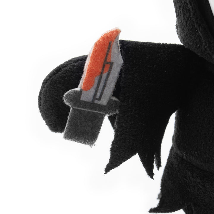 Plush toy with a black and red knife on a white background