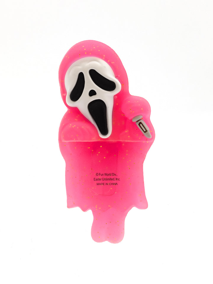 Pink ghost-shaped device with a white face design on a white background
