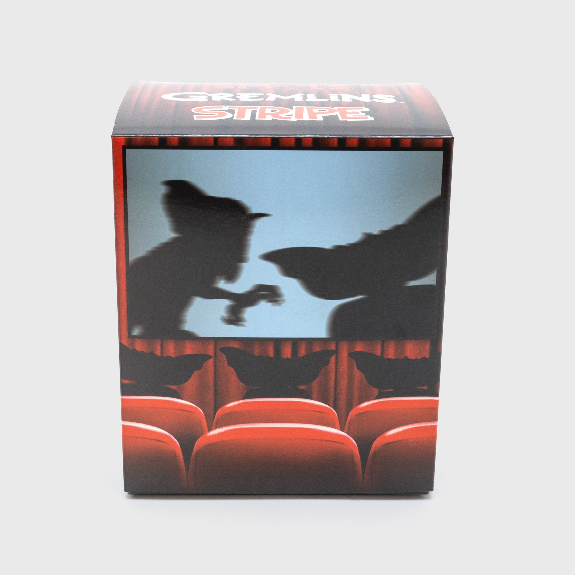 gremlins stripe smol packaging back. shows 2 gremlins on a movie screen with three gremlins in audience.
