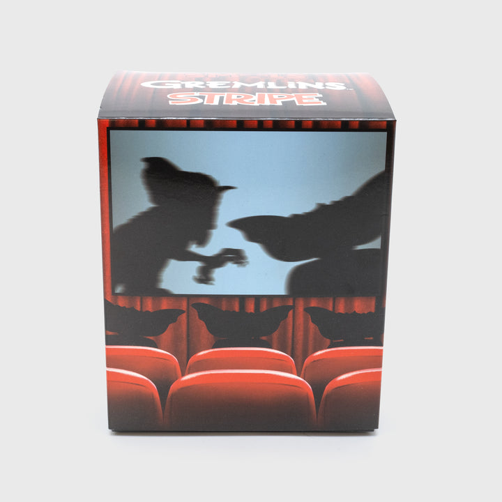 gremlins stripe smol packaging back. shows 2 gremlins on a movie screen with three gremlins in audience.