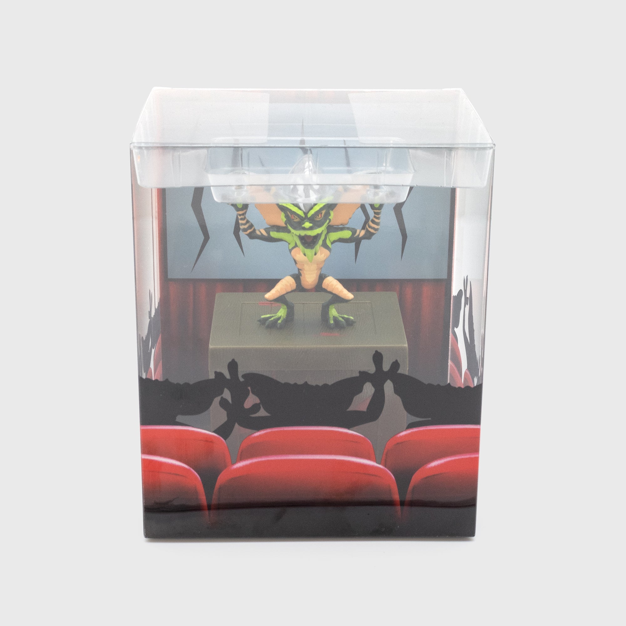 gremlins stripe smol in packaging. stripe standing on box with other gremlins seated in chairs