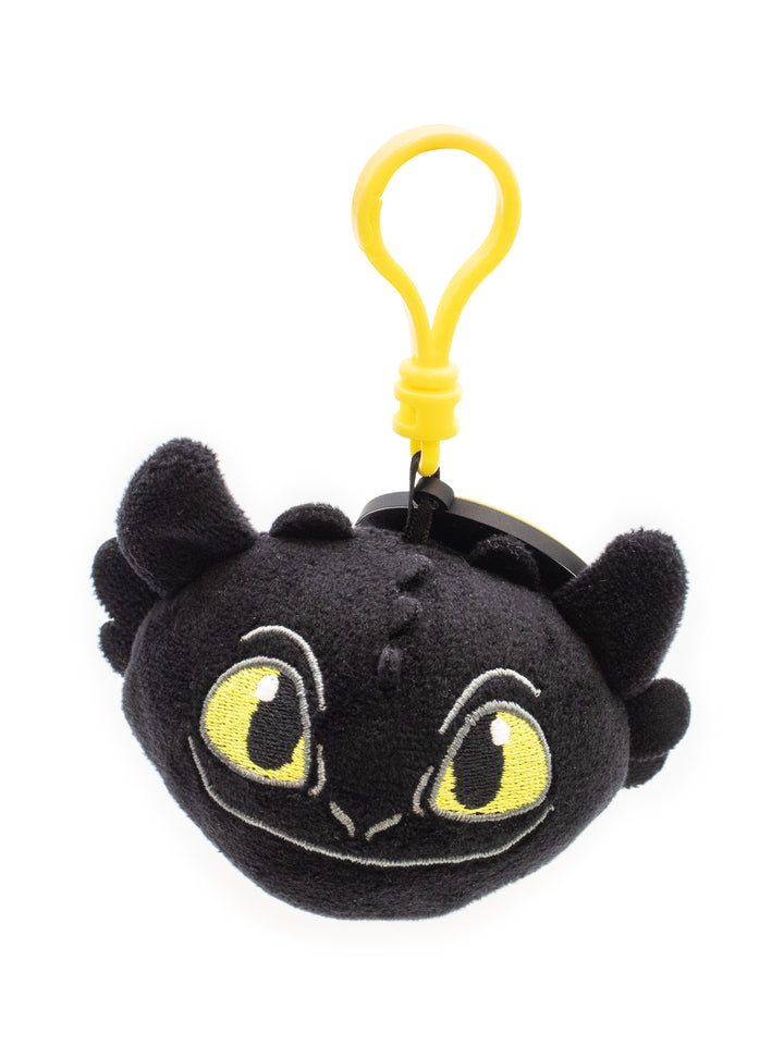Plush keychain of a dragon with yellow eyes and a yellow clip on a white background