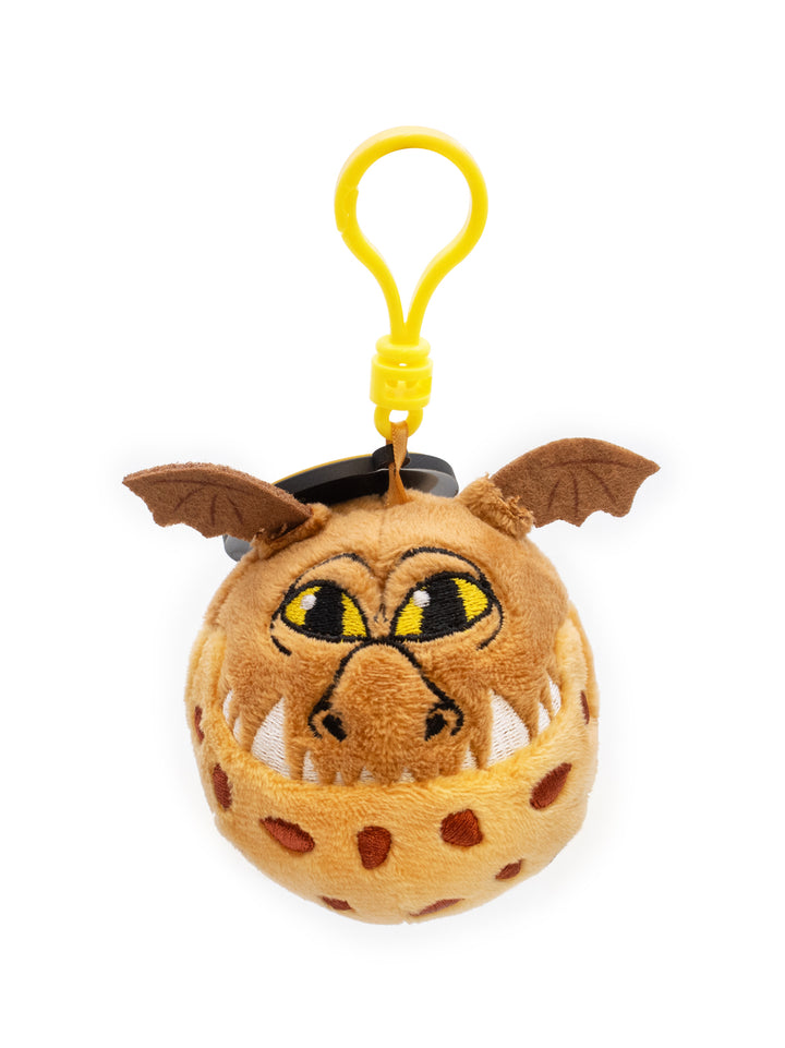 Plush keychain with a cartoonish creature in a cage on a white background