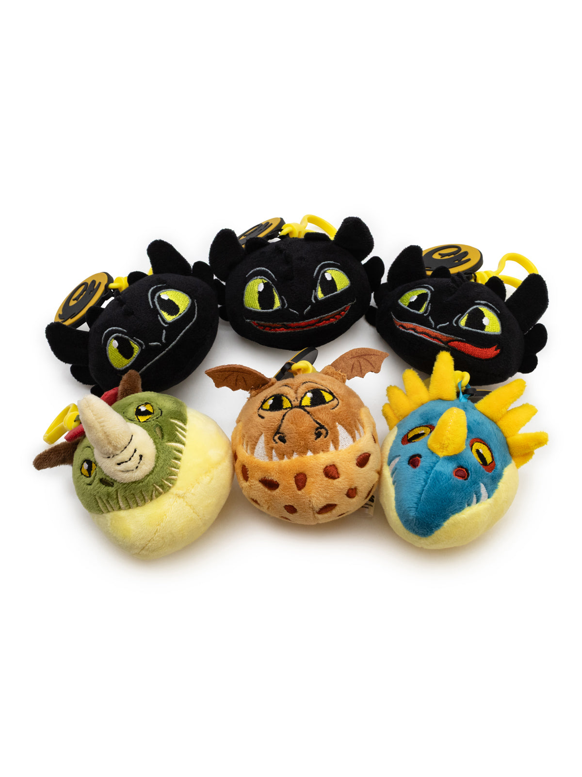 Set of plush toys resembling characters from 'How to Train Your Dragon' on a white background