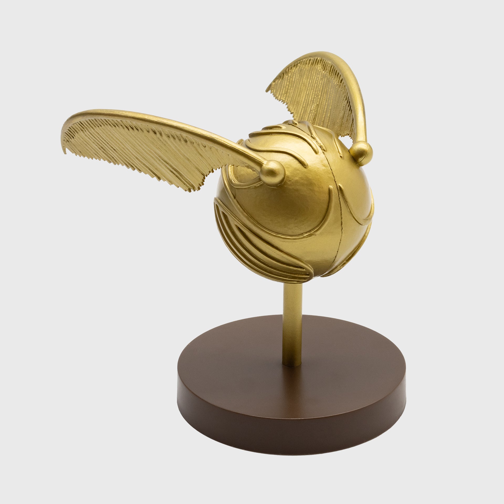 golden snitch vinyl figure. snitch on stand.