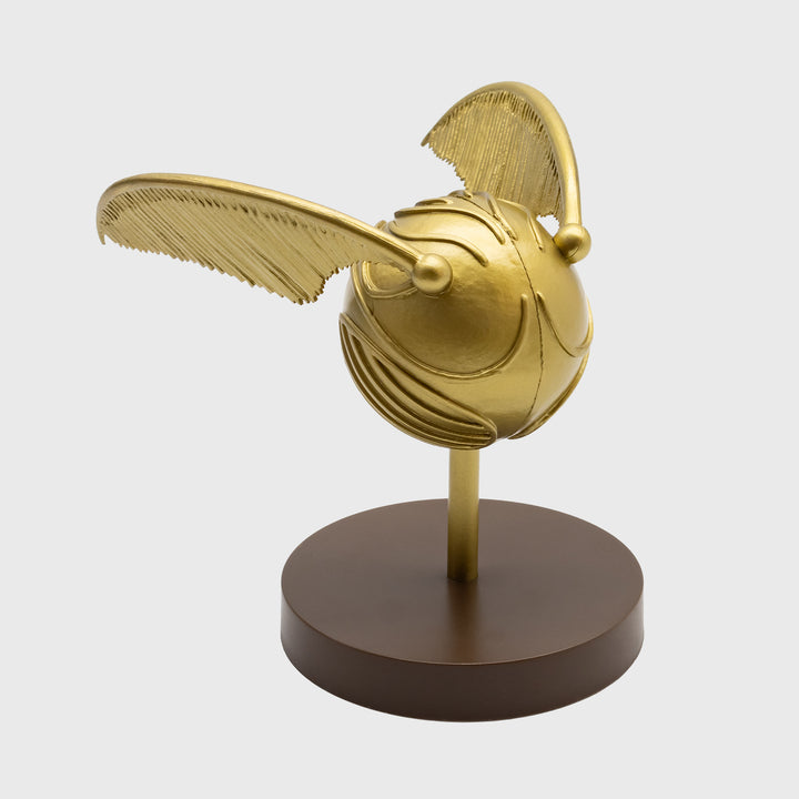 golden snitch vinyl figure. snitch on stand.
