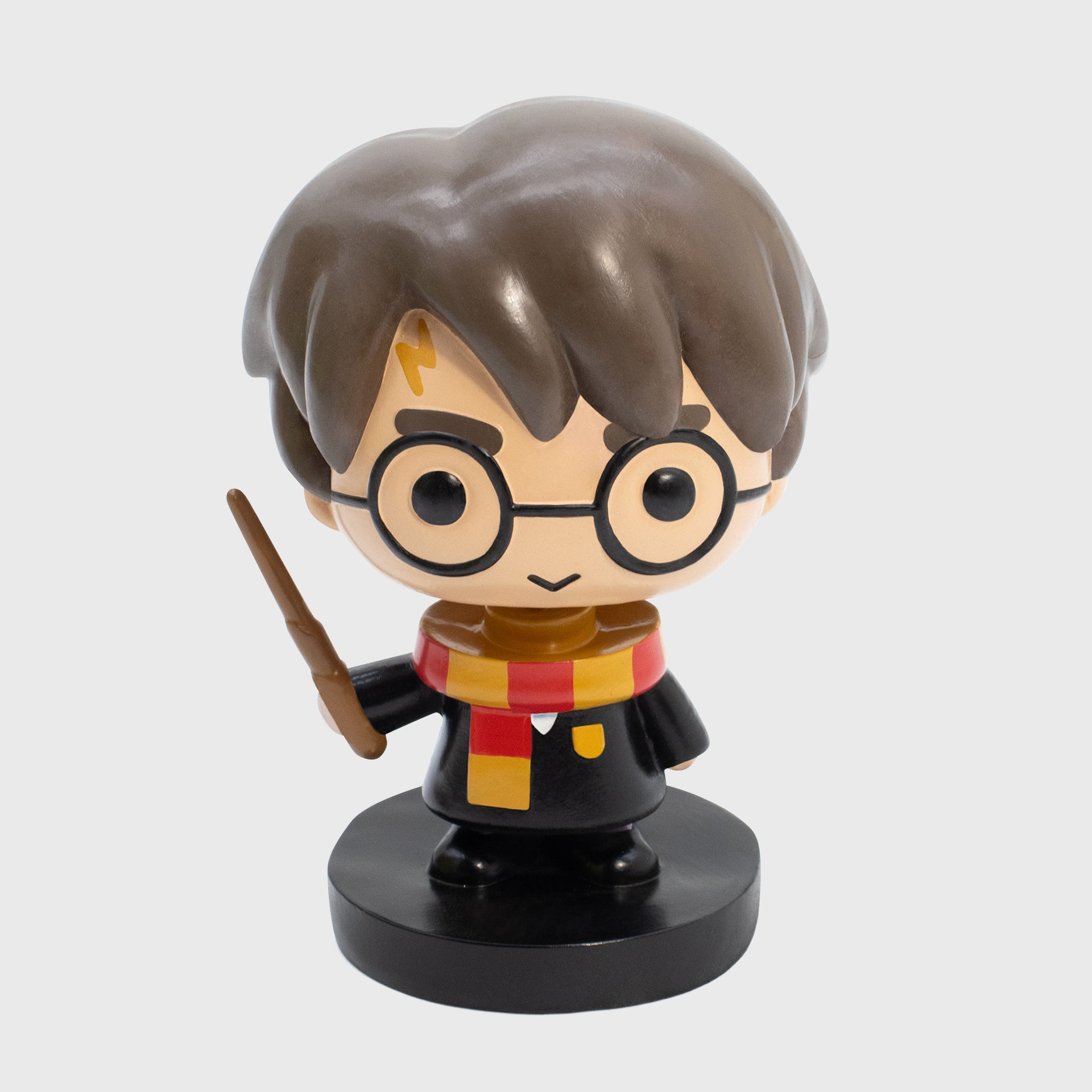 harry potter bobblehead. harry wearing scarf and hogwarts uniform holding wand. on black stand/