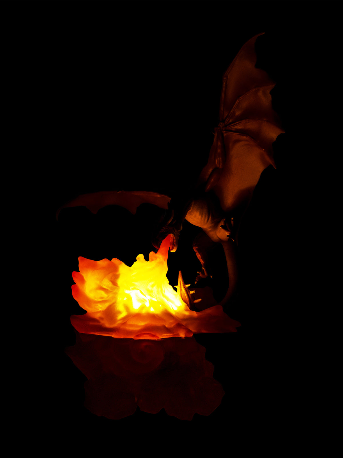 dragon emerging from a glowing ball of light against a dark background