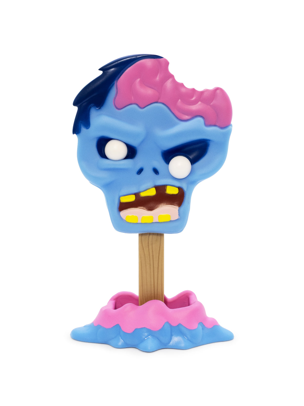 A toy figure of a zombie head with a bite taken out of the top, mounted on a wooden stick and standing in a pink and blue melted base, isolated on a white background.