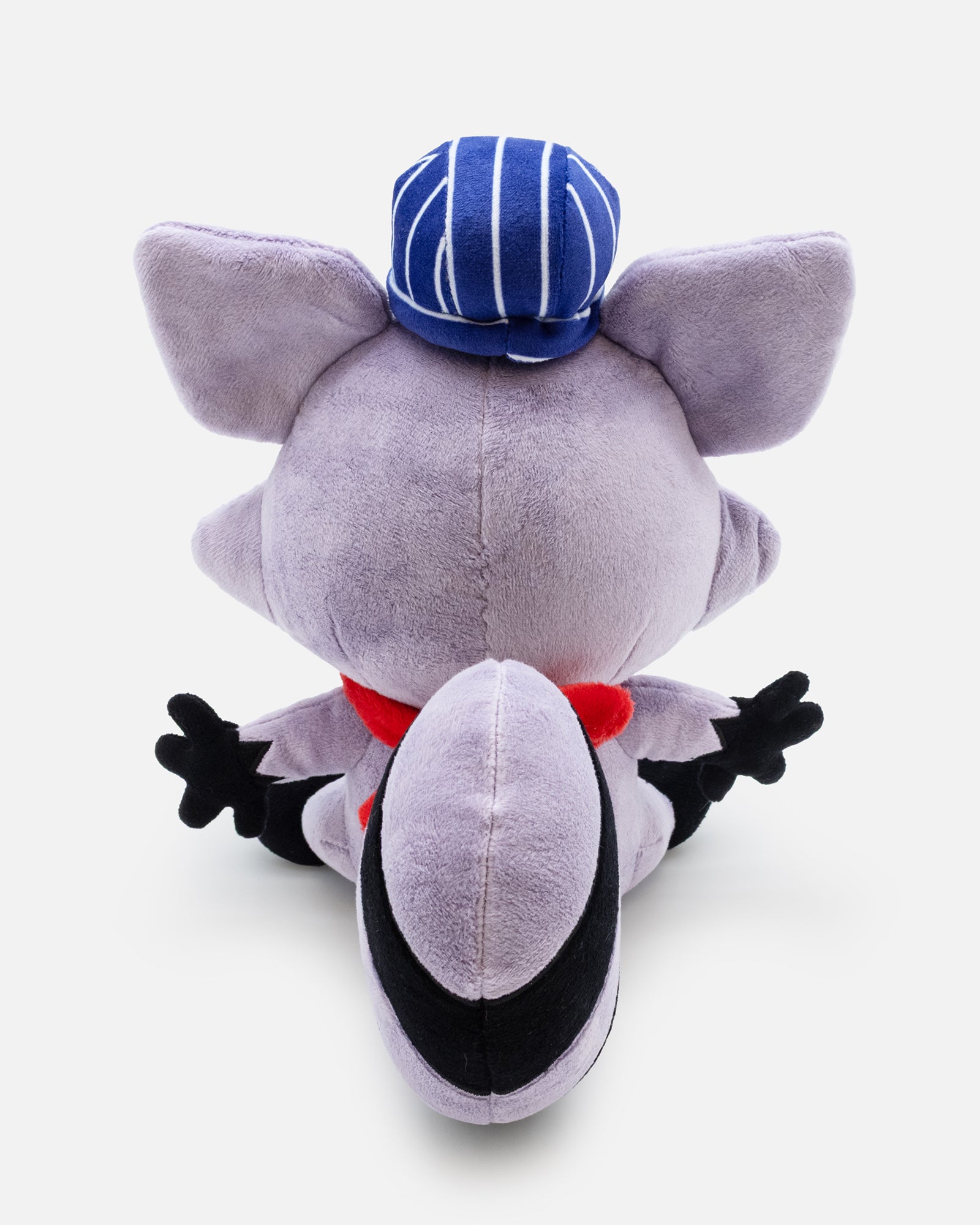 Gray plush toy with a blue cap and red scarf on a white background