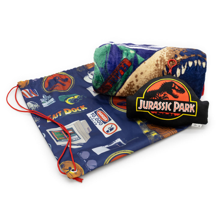 Jurassic Park-themed pillow and plush toy set on a blue patterned mat