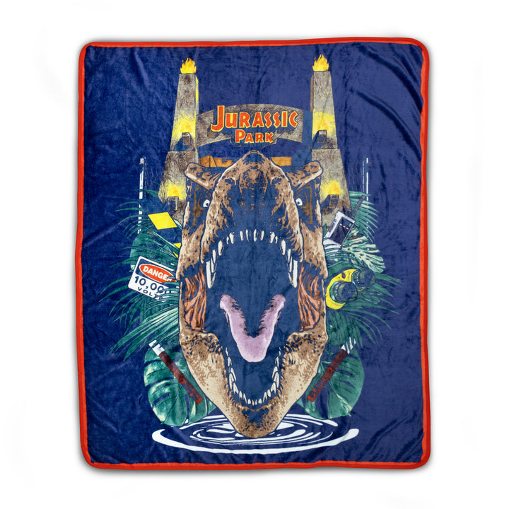 Blanket with a dinosaur design and 'Jurassic Park' text on a blue background
