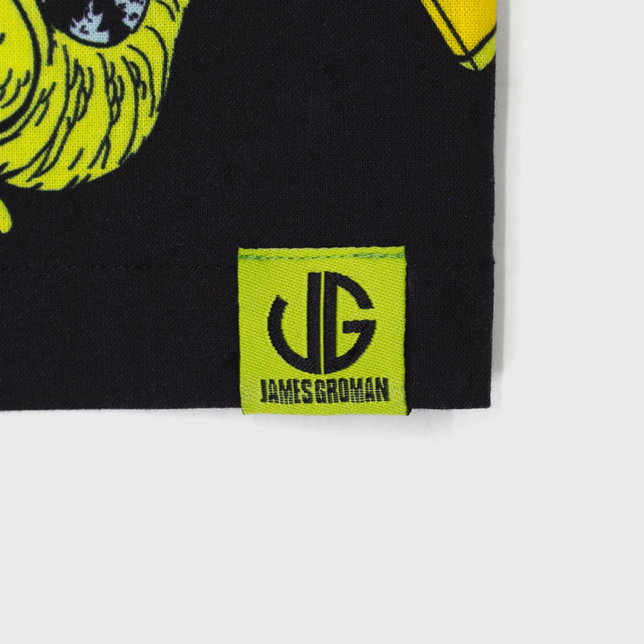 james groman reptar woven shirt. close up of tag on bottom. image: james groman logo. text: james groman