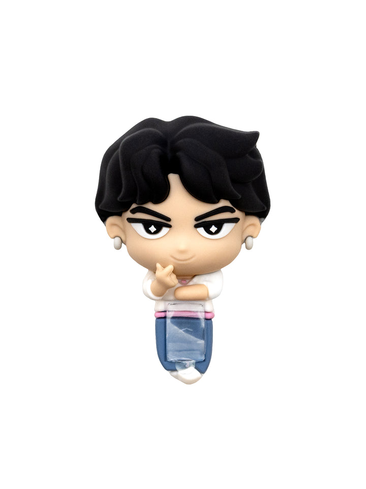 A small stylized collectible figure of a person with black hair, large eyes, and a white-and-blue outfit, shown centered on a plain white background.
