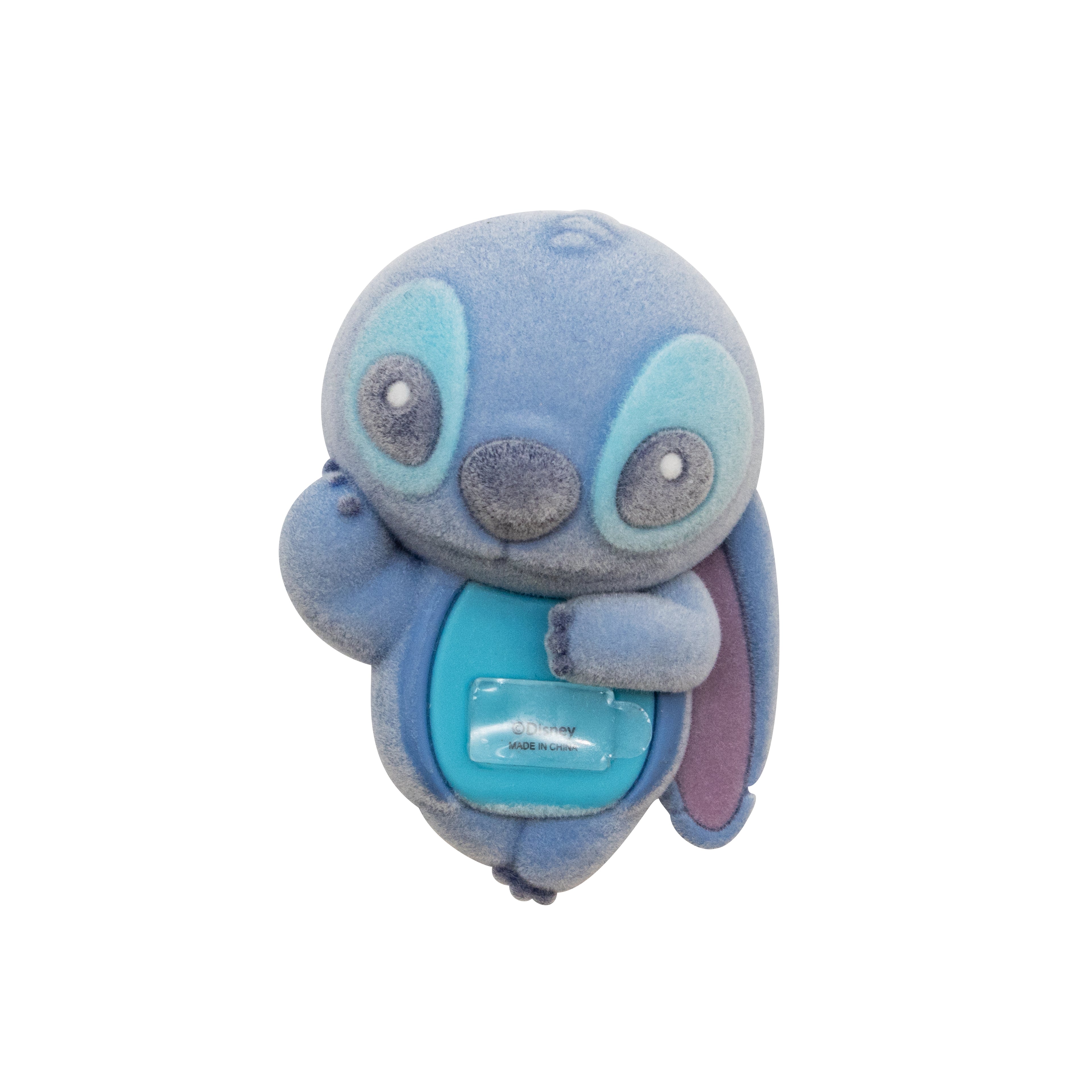 A blue plush toy character with large eyes, a gray snout, and a small clear plastic attached to its chest, shown against a plain white background.